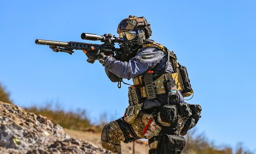 Magfed milsim player with scoped marker and full loadout