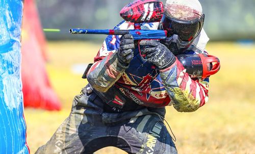 Tournament airball player behind inflatable bunker — NXL-style speedball